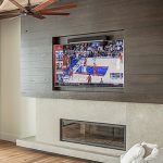 TV and soundbar installed in constructed pocket over a fireplace