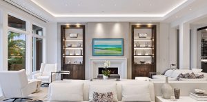 Living room with white furniture and custom wood cabinetry featuring carefully designed lighting by CAV Integrated Home to minimize shadows and enhance the ambiance.