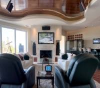 Fireplace television installed with Bowers & Wilkins 802 Nautilus Series speakers in a modern decor room on Wilmington Island, Savannah, Georgia.