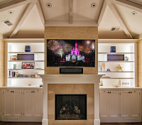 Fireplace television installation in this study features a Samsung 60” LCD television and Bowers & Wilkins bookshelf speakers in a 5.1 surround sound configuration, installed in a beachside home in Hilton Head Island, South Carolina.